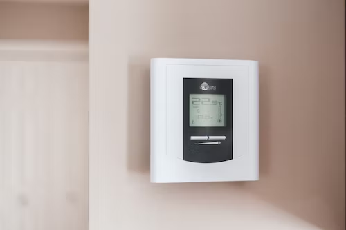 a white thermostat with temperature